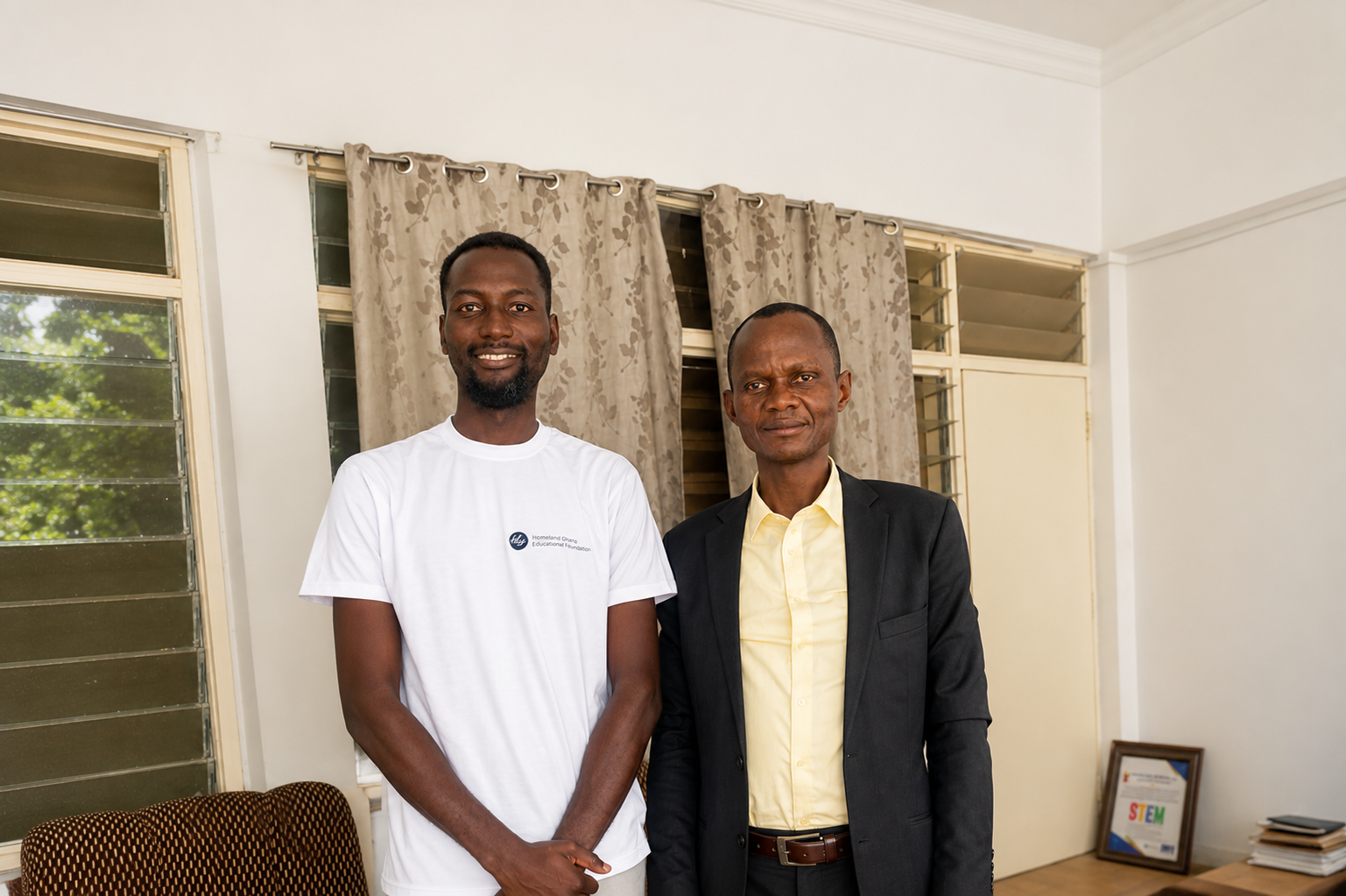 Homeland Ghana staff member meeting with Builsa North Municipal Director of Education, Gabriel Johnson, to discuss improving basic education in Ghana